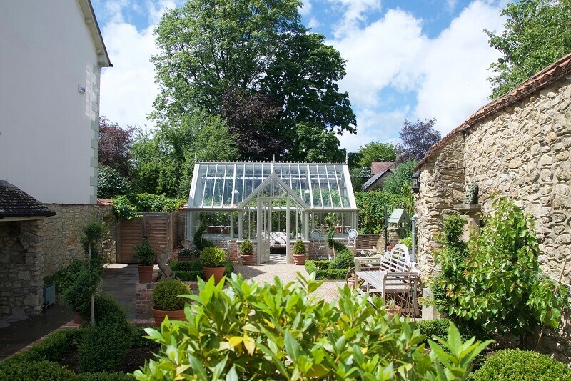 Small Messenger greenhouse in walled garden