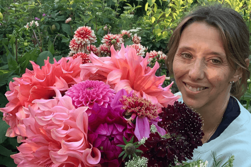 Helier Bowling, the Garden Goddess, with a bouquet of homegrown flowers.