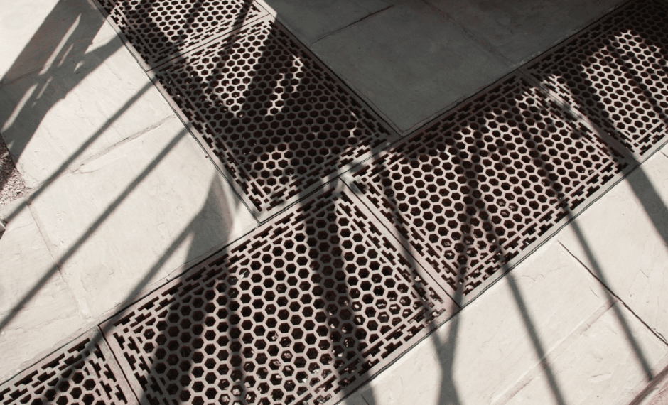 Cast Iron Floor Grids forming a T junction in an aluminium victorian greenhouse