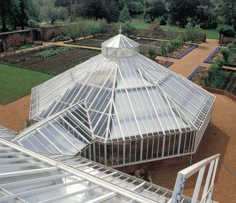 Octagonal aluminium greenhouse with walkway to lean-to greenhouse