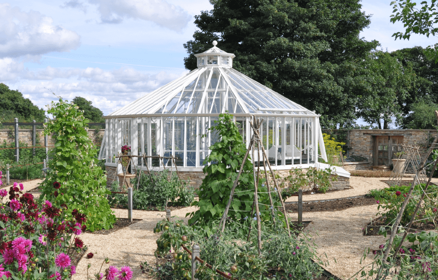 Alitex aluminium octagonal glasshouse in a walled kitchen garden