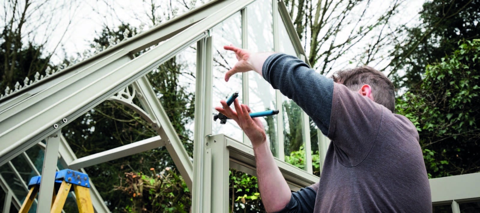 Alitex Installer re-glazing greenhouse