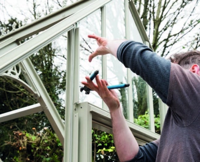 Alitex Installer re-glazing greenhouse