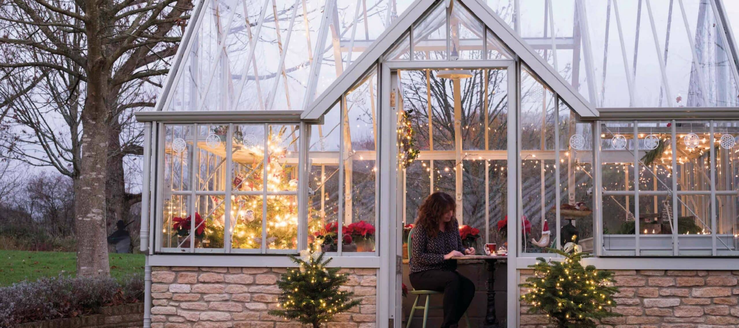 Lady in greenhouse at christmas