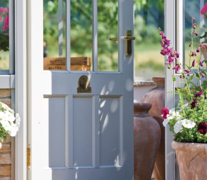 Straight on view of an Alitex glasshouse with the door ajar.
