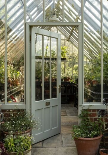 Inside of the greenhouse shown through a partial open door