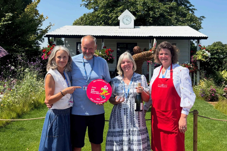 Steve Moody, designer of The Cricket Pavilion Garden, with Nelly and Rachel Gibson from the Young at Heart Heathfield community group, proudly holding the RHS Best in Show award at the RHS Badminton Flower Show.